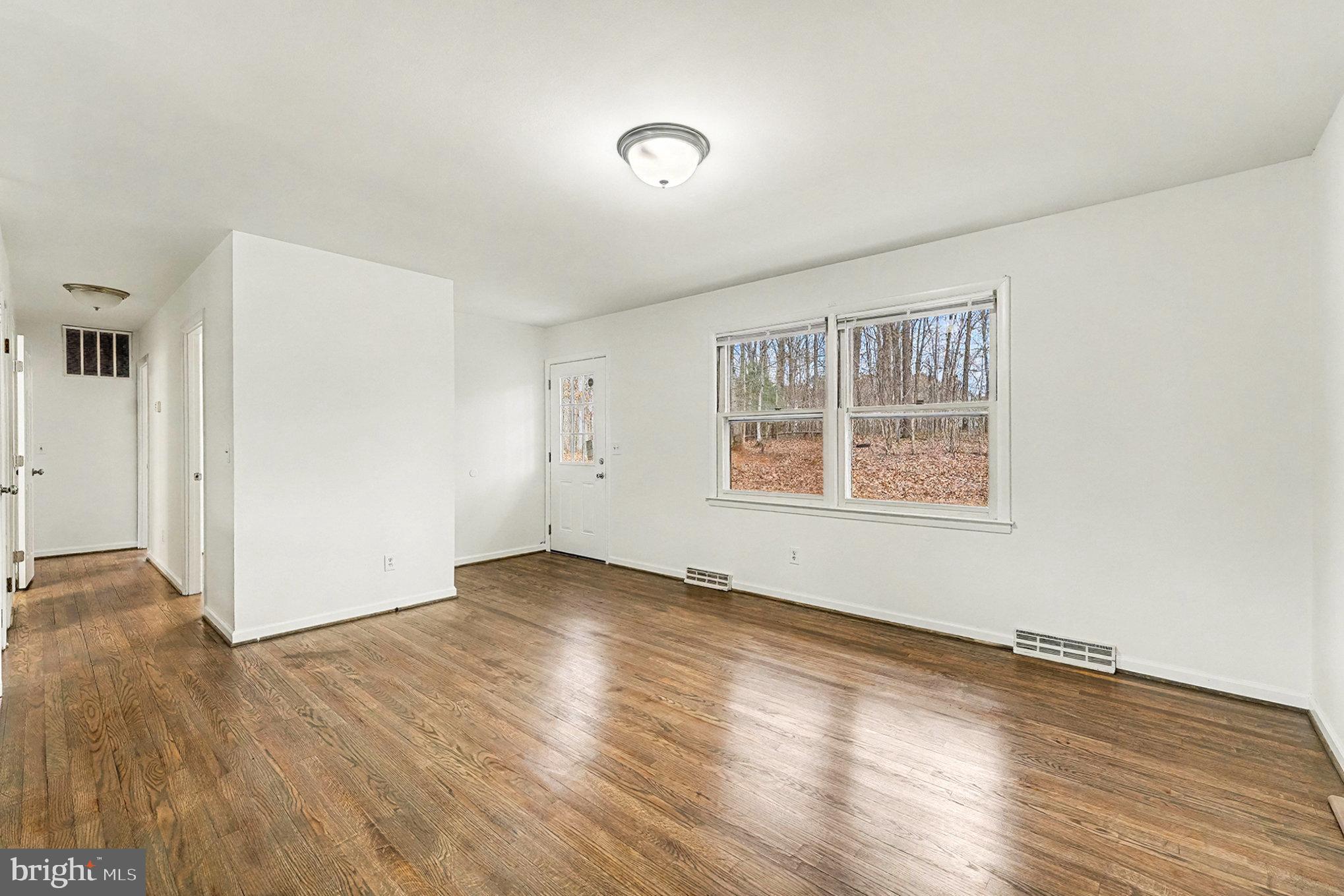 4127 Cabin Road Reva, VA 22735 - Photo 8 of 28 an empty room with wooden floor and windows