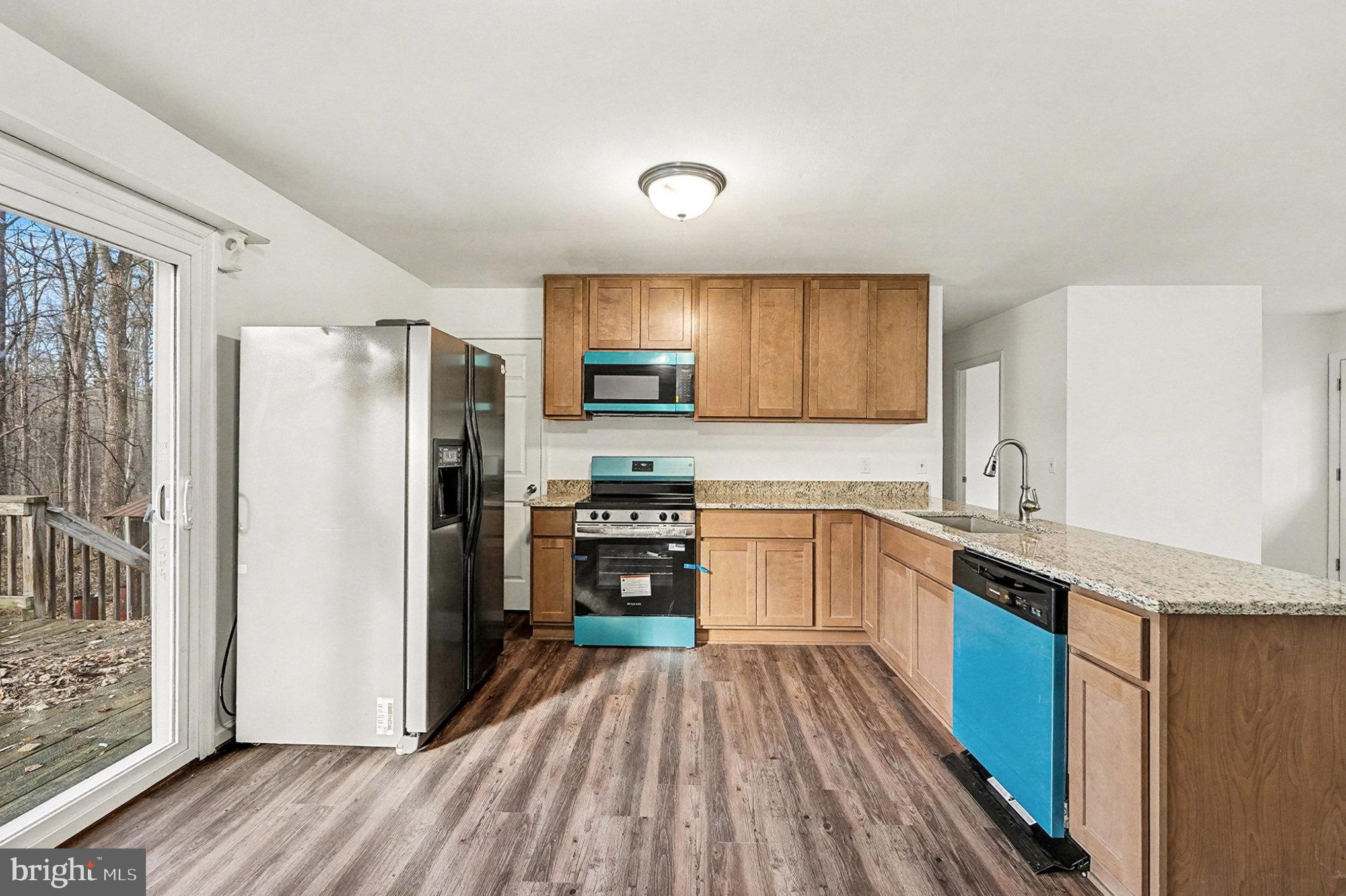 4127 Cabin Road Reva, VA 22735 - Photo 10 of 28 a kitchen with granite countertop a refrigerator stove and sink