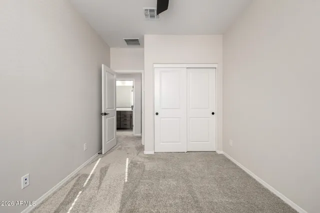 an empty room with a window and a ceiling fan