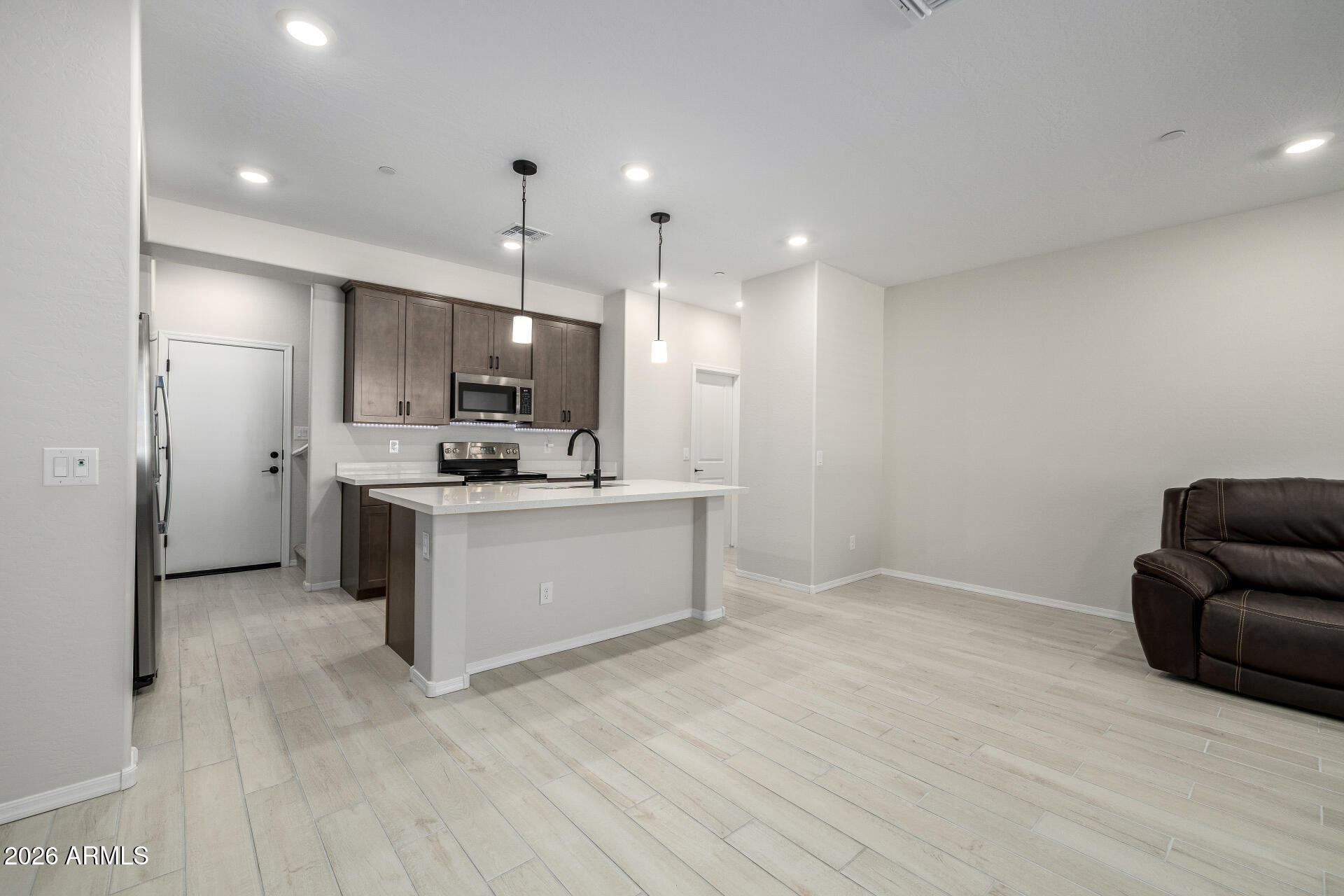 1850 East Bernie Lane, Unit 102 Gilbert, AZ 85295 - Photo 2 of 62 a view of kitchen with kitchen island stainless steel appliances refrigerator sink and cabinets