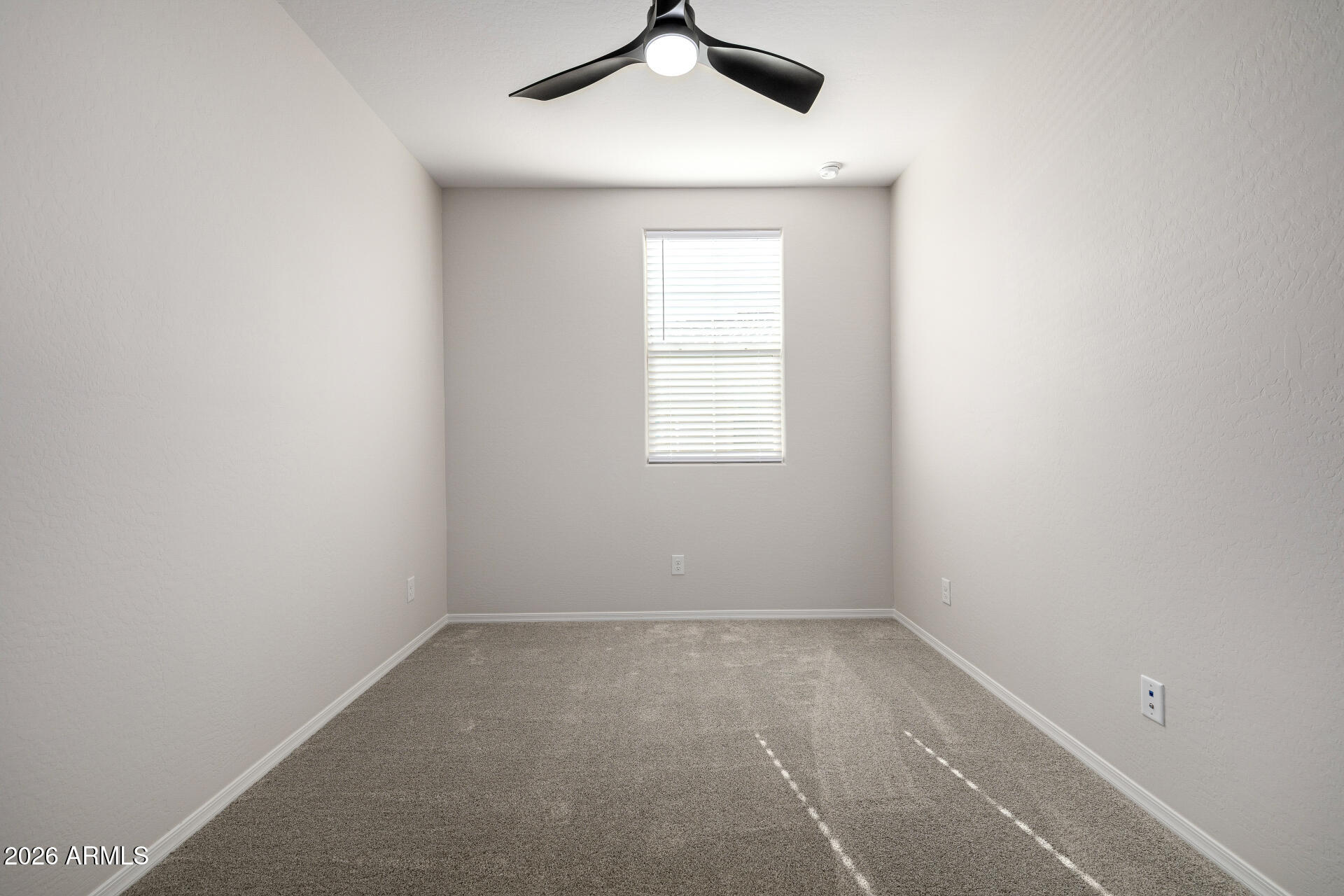1850 East Bernie Lane, Unit 102 Gilbert, AZ 85295 - Photo 21 of 62 an empty room with a window and a ceiling fan
