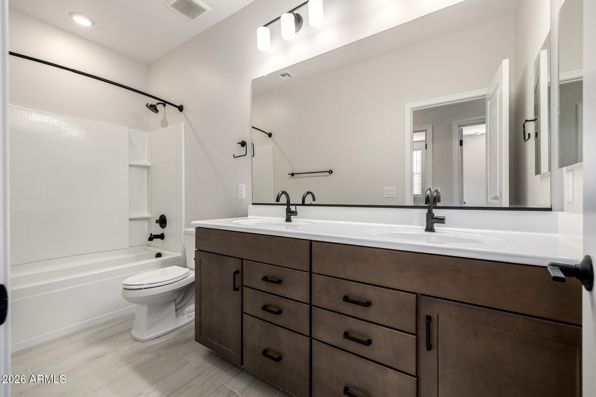 1850 East Bernie Lane, Unit 102 Gilbert, AZ 85295 - Photo 22 of 62 a bathroom with a double vanity sink toilet mirror and shower