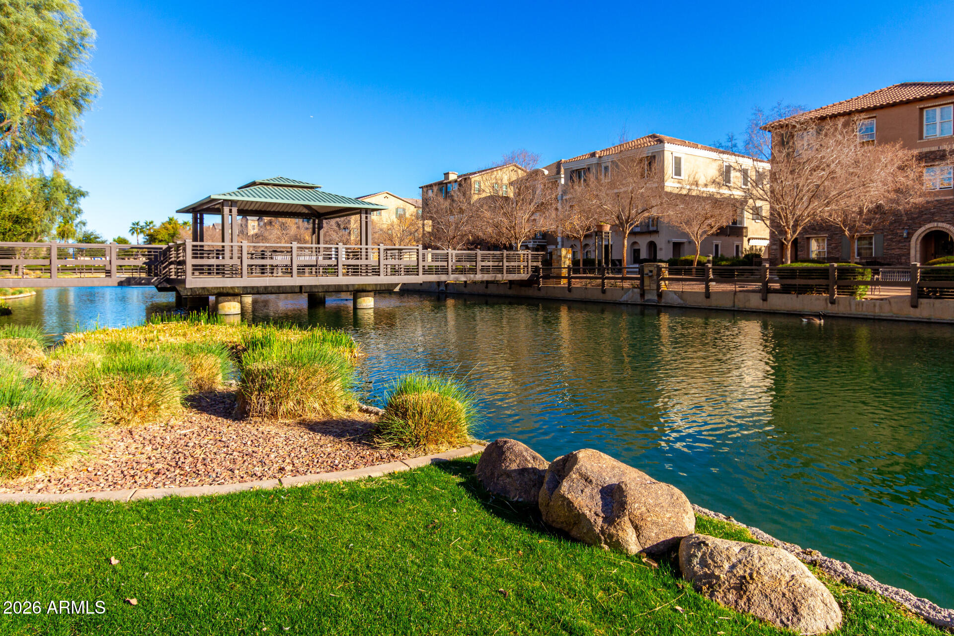 1850 East Bernie Lane, Unit 102 Gilbert, AZ 85295 - Photo 39 of 62 a view of a house with a yard and a pond