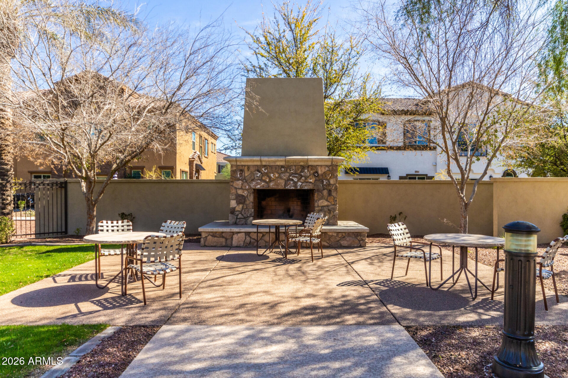 1850 East Bernie Lane, Unit 102 Gilbert, AZ 85295 - Photo 46 of 62 a view of a patio with table and chairs and a fire pit