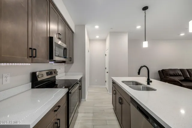 a kitchen that has a sink and a stove