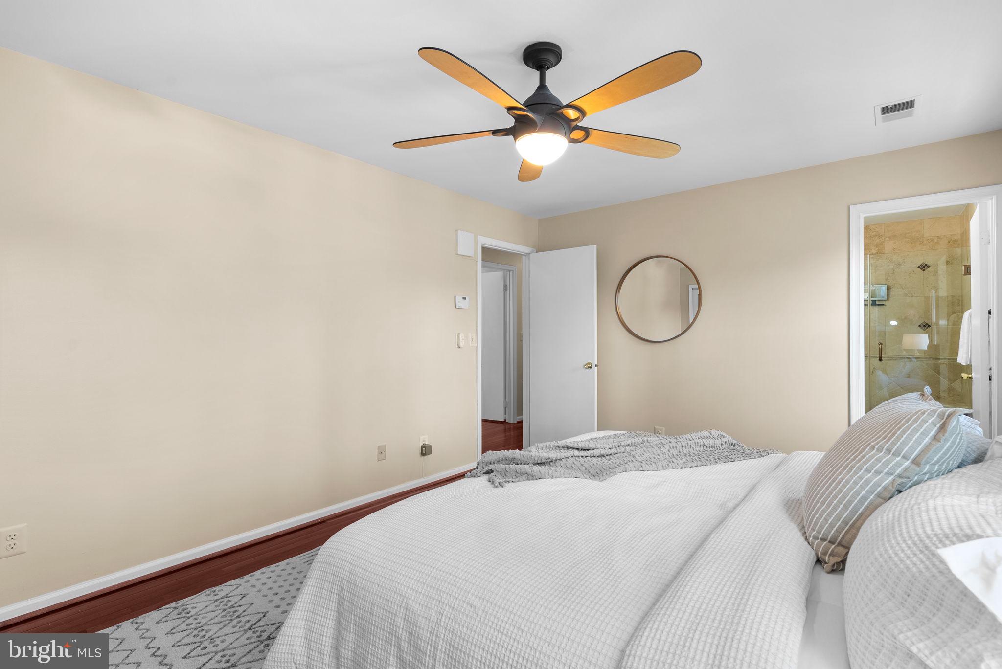 122 Hamilton Avenue Silver Spring, MD 20901 - Photo 22 of 45 a bedroom with a large bed and a chandelier