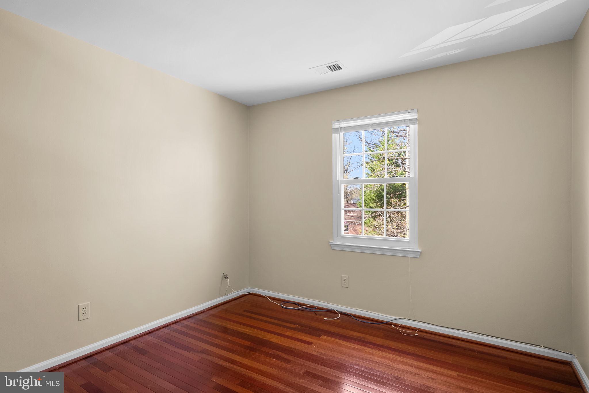 122 Hamilton Avenue Silver Spring, MD 20901 - Photo 25 of 45 a view of an empty room with wooden floor and a window