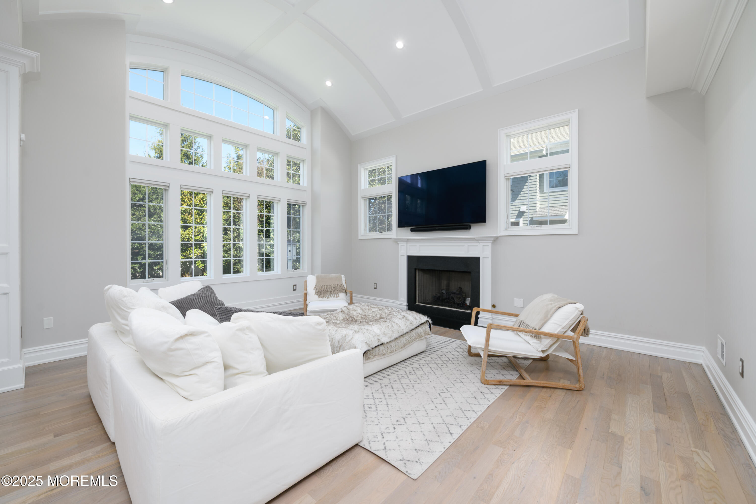 98 Harvard Road Fair Haven, NJ 07704 - Photo 11 of 51 a living room with furniture a flat screen tv and a fireplace