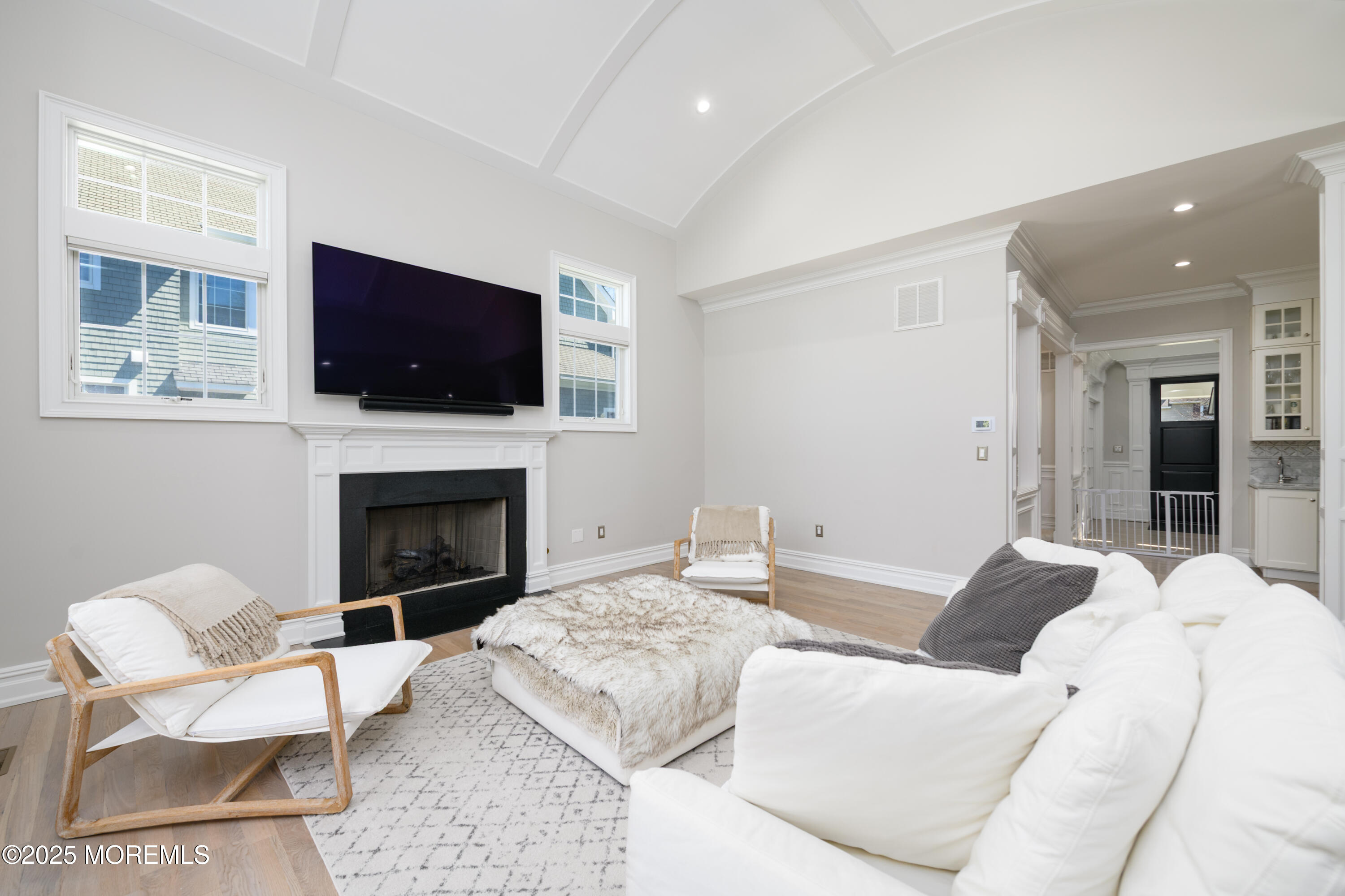 98 Harvard Road Fair Haven, NJ 07704 - Photo 15 of 51 a living room with furniture a flat screen tv and a fireplace