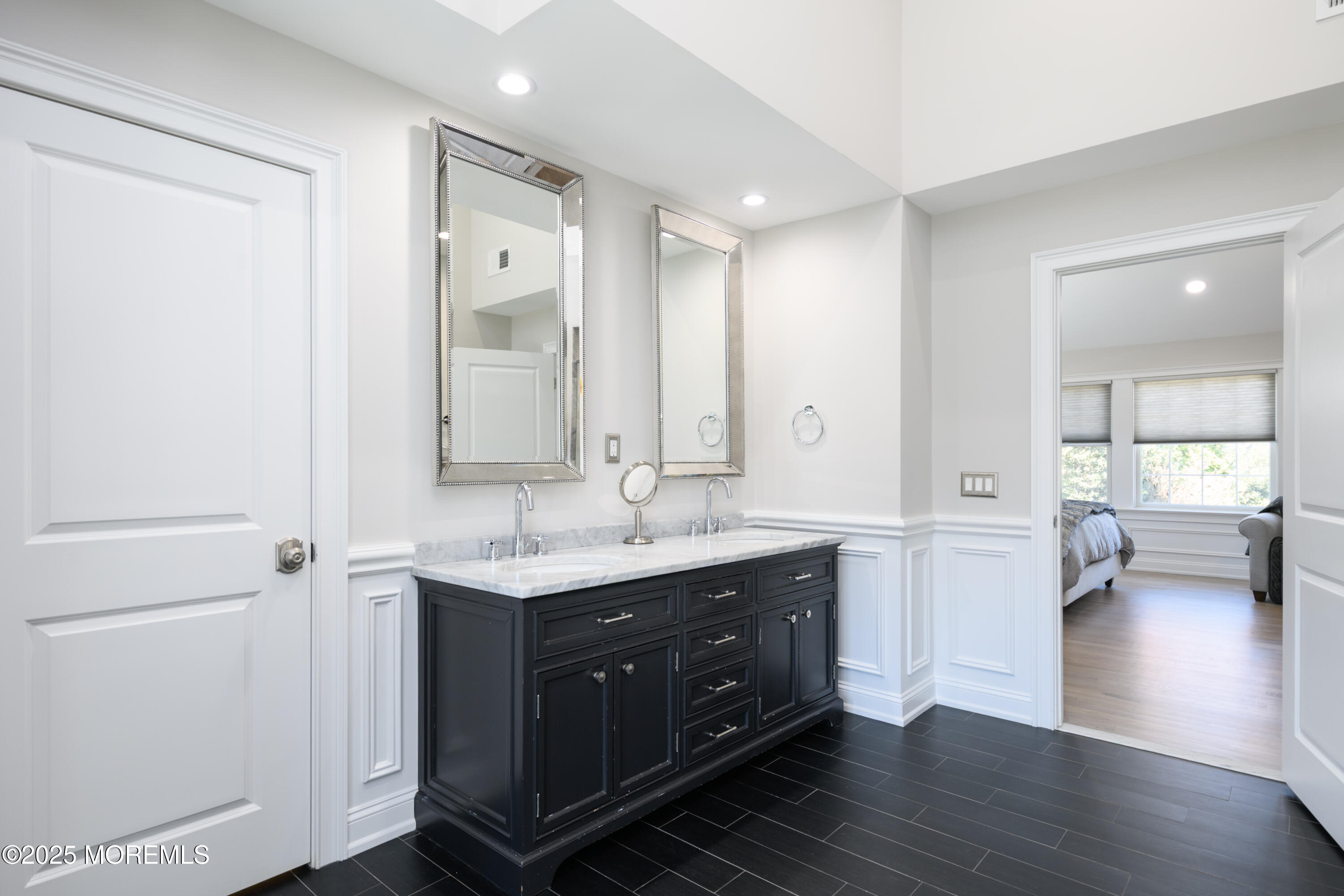 98 Harvard Road Fair Haven, NJ 07704 - Photo 23 of 51 a spacious bathroom with a granite countertop sink a mirror and a bathtub