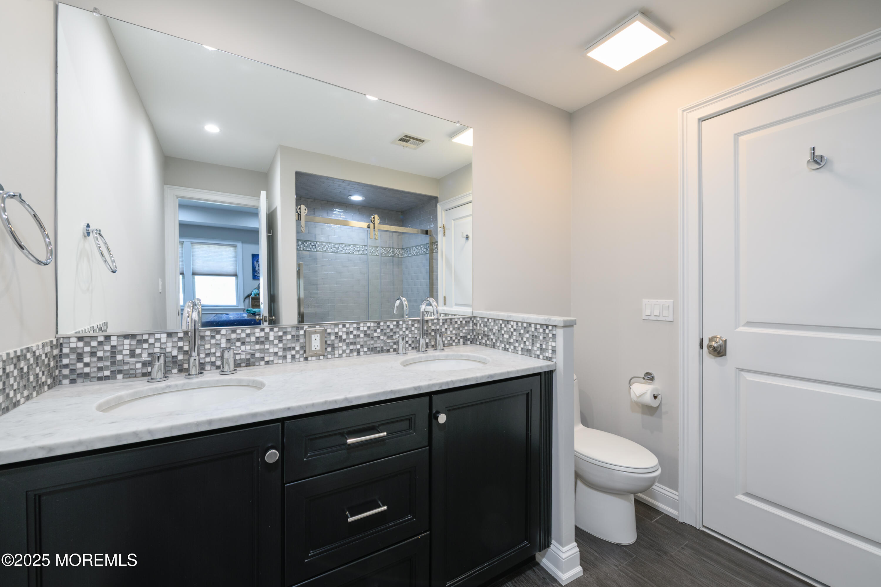 98 Harvard Road Fair Haven, NJ 07704 - Photo 27 of 51 a bathroom with a granite countertop sink a toilet and a mirror