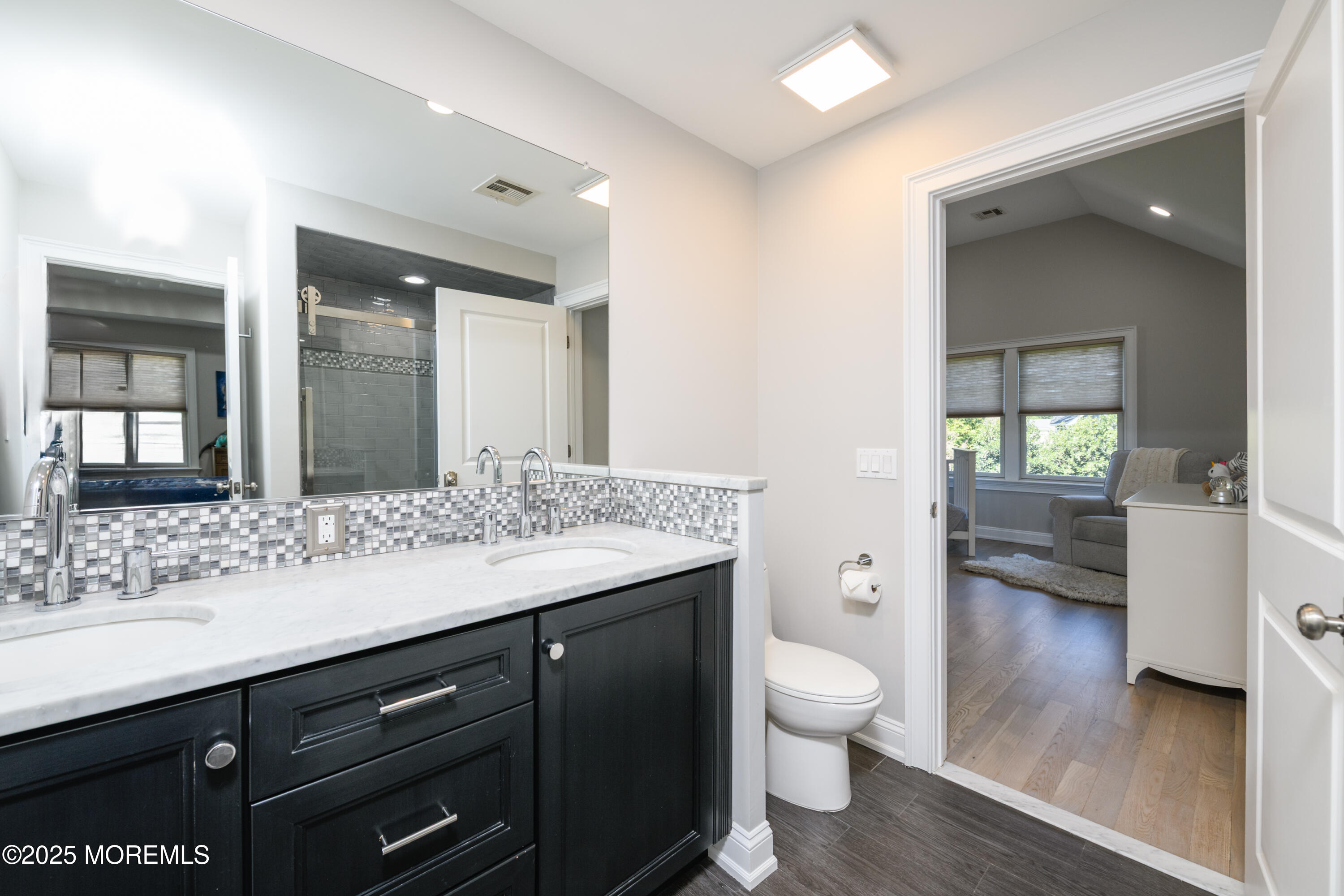 98 Harvard Road Fair Haven, NJ 07704 - Photo 28 of 51 a bathroom with a granite countertop sink a toilet and a large mirror