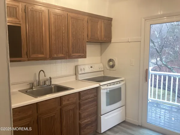 a kitchen with a sink stove and cabinets