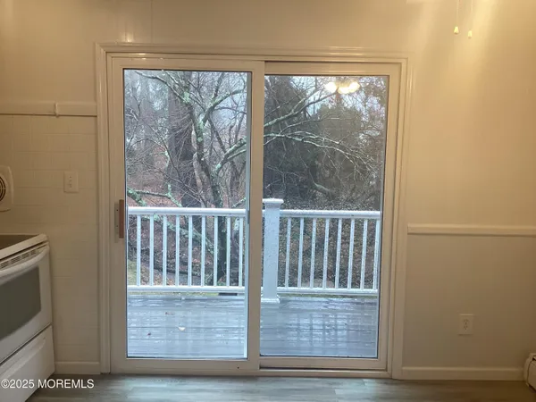 a view of a room with wooden floor and a window