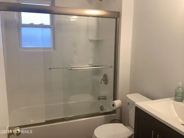 a bathroom with a shower a toilet and sink