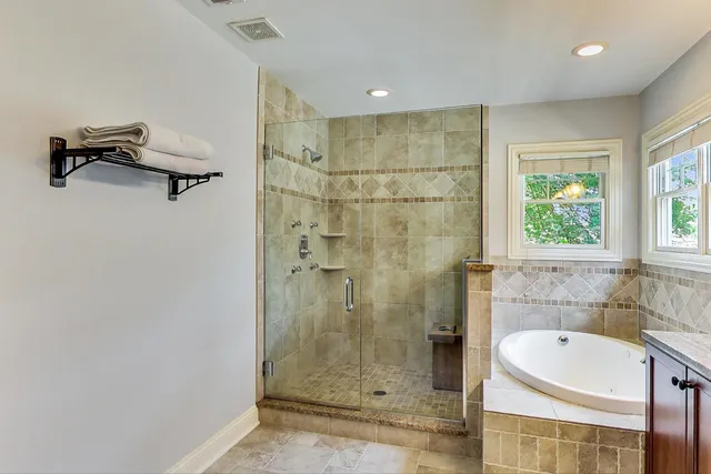 a bathroom with a bathtub and shower