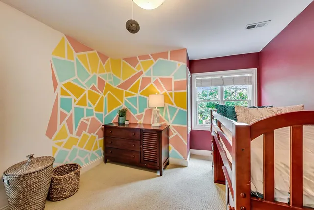 a living room with furniture a air conditioner vent and a window