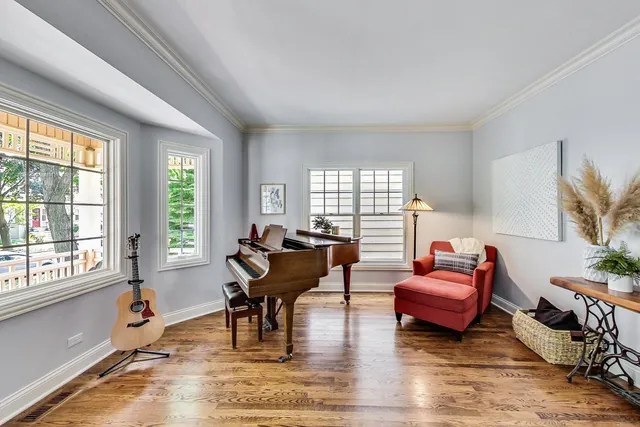 a living room with furniture wooden floor and a window
