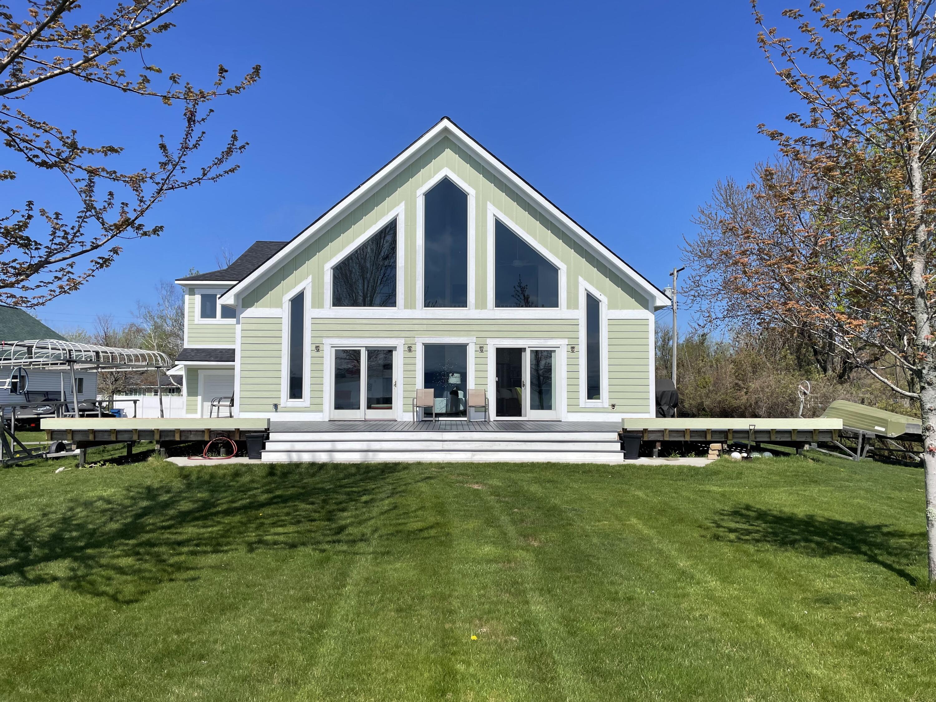 8579 Bayview Road Onekama, MI 49675 - Photo 10 of 72 Wraparound deck with flower boxes