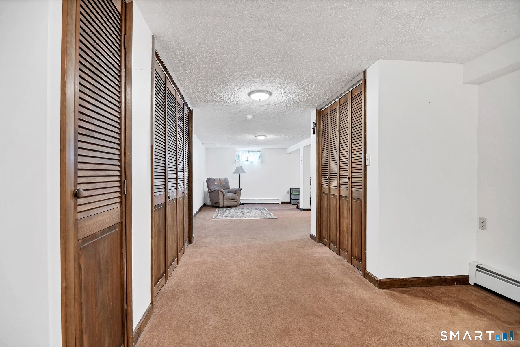 110 Meadow Lark Road Naugatuck, CT 06770 - Photo 16 of 40 a view of a hallway with wooden floor and a bathroom