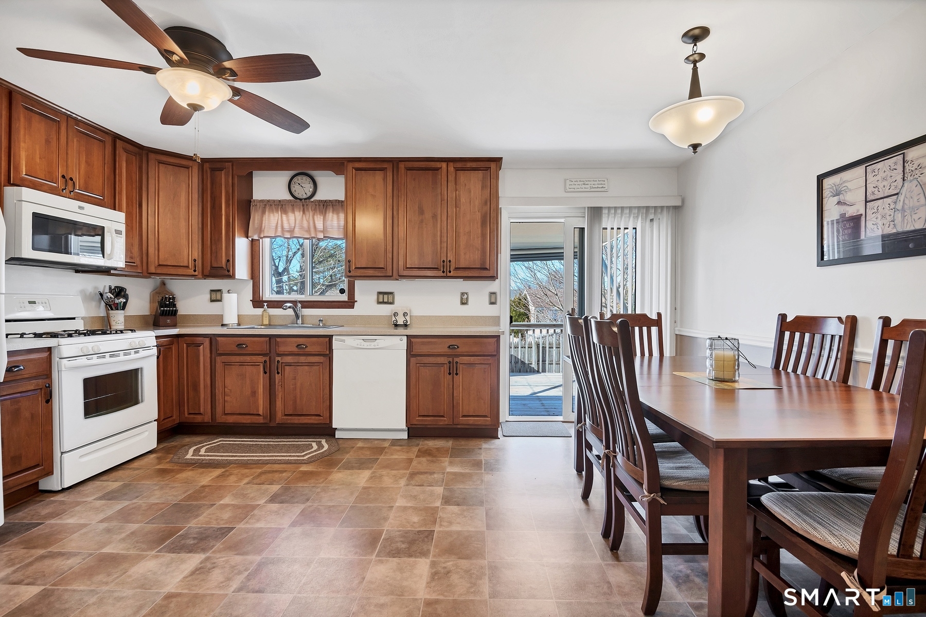 110 Meadow Lark Road Naugatuck, CT 06770 - Photo 2 of 40 a kitchen with a stove a sink a dining table and chairs