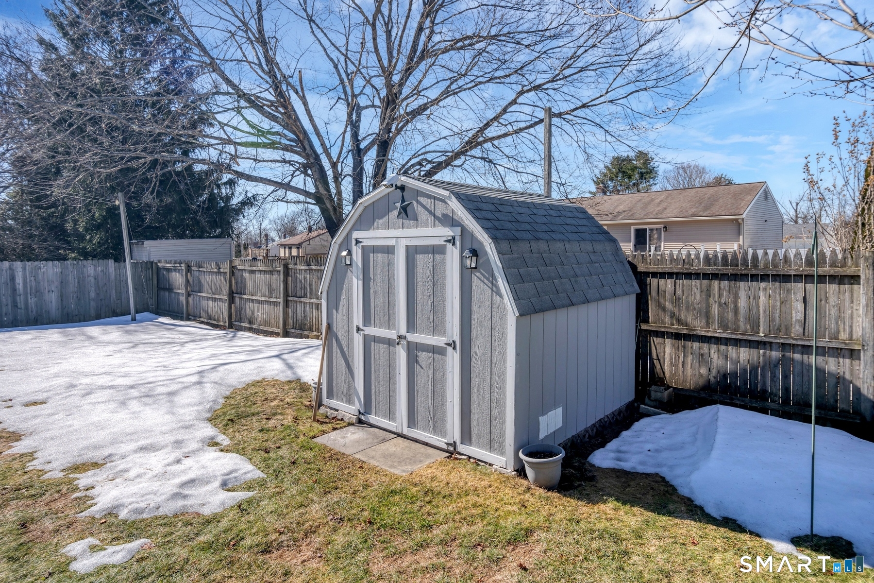 110 Meadow Lark Road Naugatuck, CT 06770 - Photo 34 of 40 a view of a backyard with a large tree and wooden fence