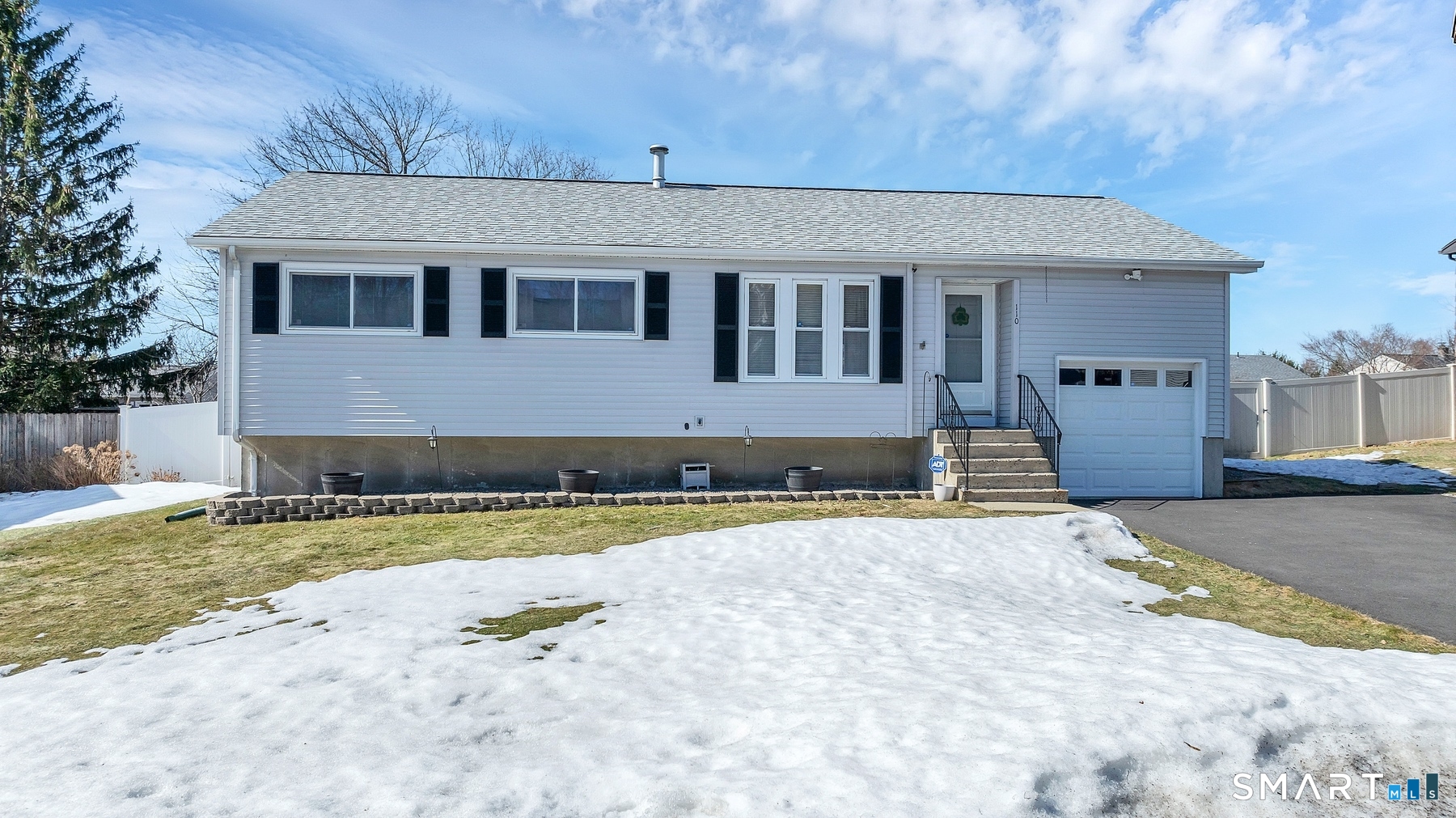110 Meadow Lark Road Naugatuck, CT 06770 - Photo 36 of 40 a front view of a house with a yard and garage