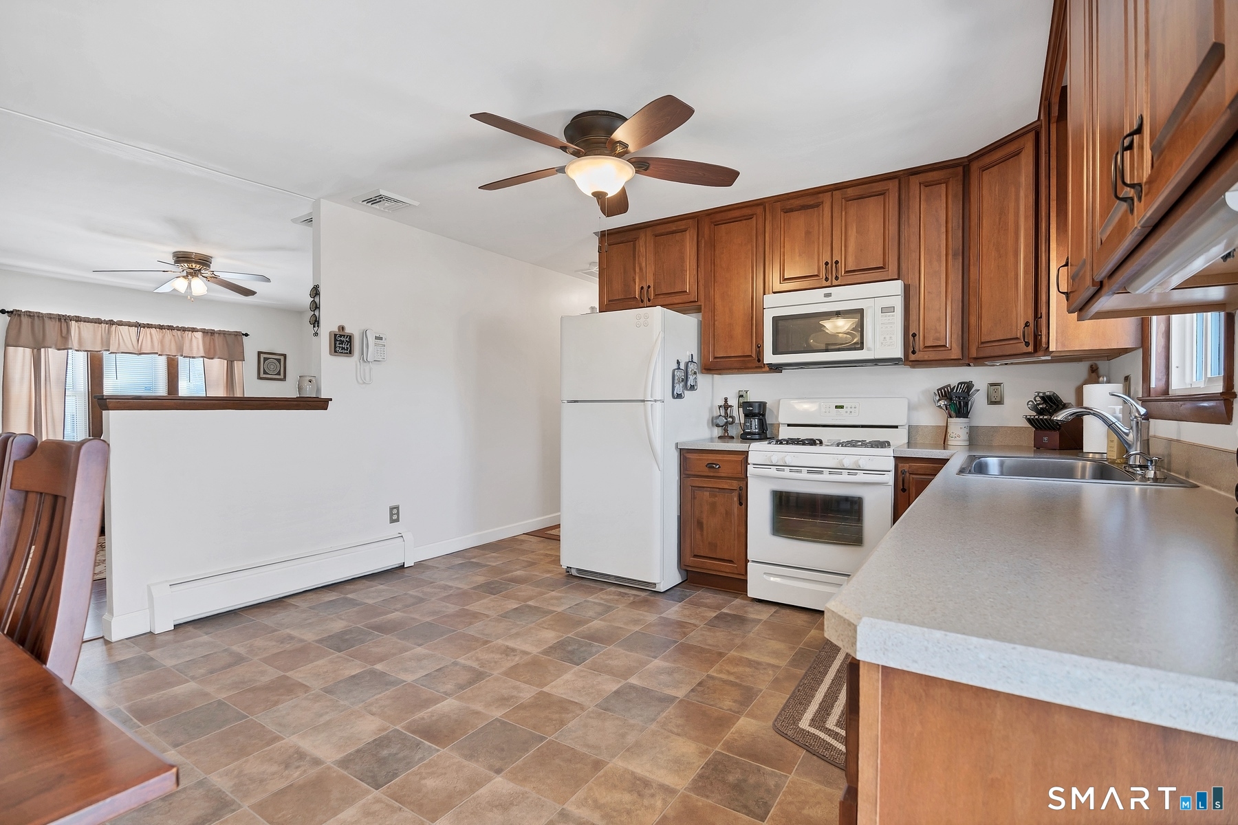 110 Meadow Lark Road Naugatuck, CT 06770 - Photo 4 of 40 a kitchen with a stove a sink and a refrigerator