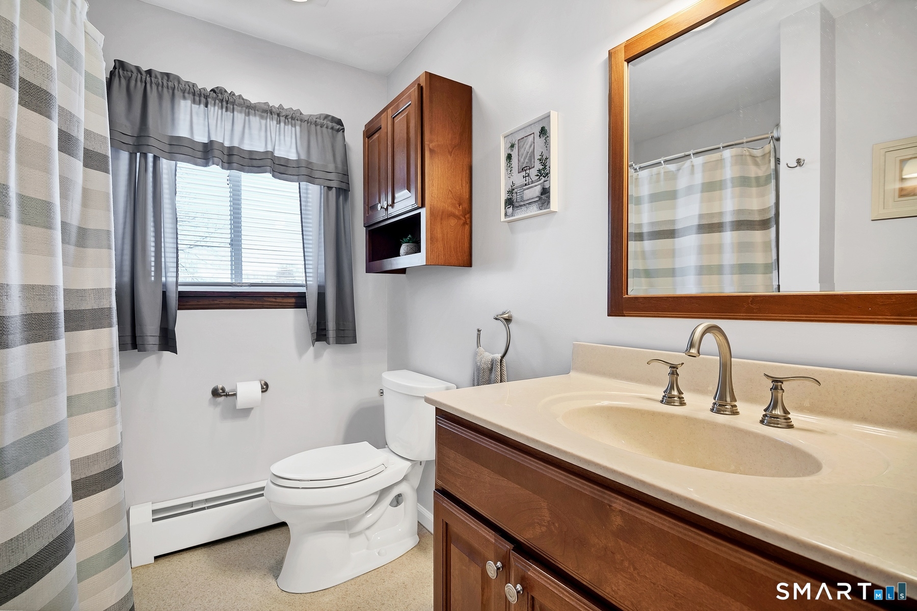 110 Meadow Lark Road Naugatuck, CT 06770 - Photo 9 of 40 a bathroom with a toilet a sink a mirror a window and vanity