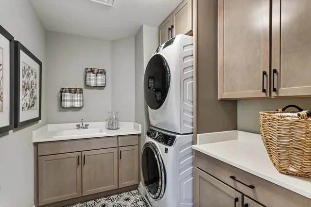 a utility room with sink dryer and washer