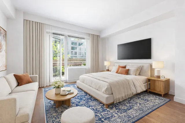 a bedroom with a bed and a flat screen television