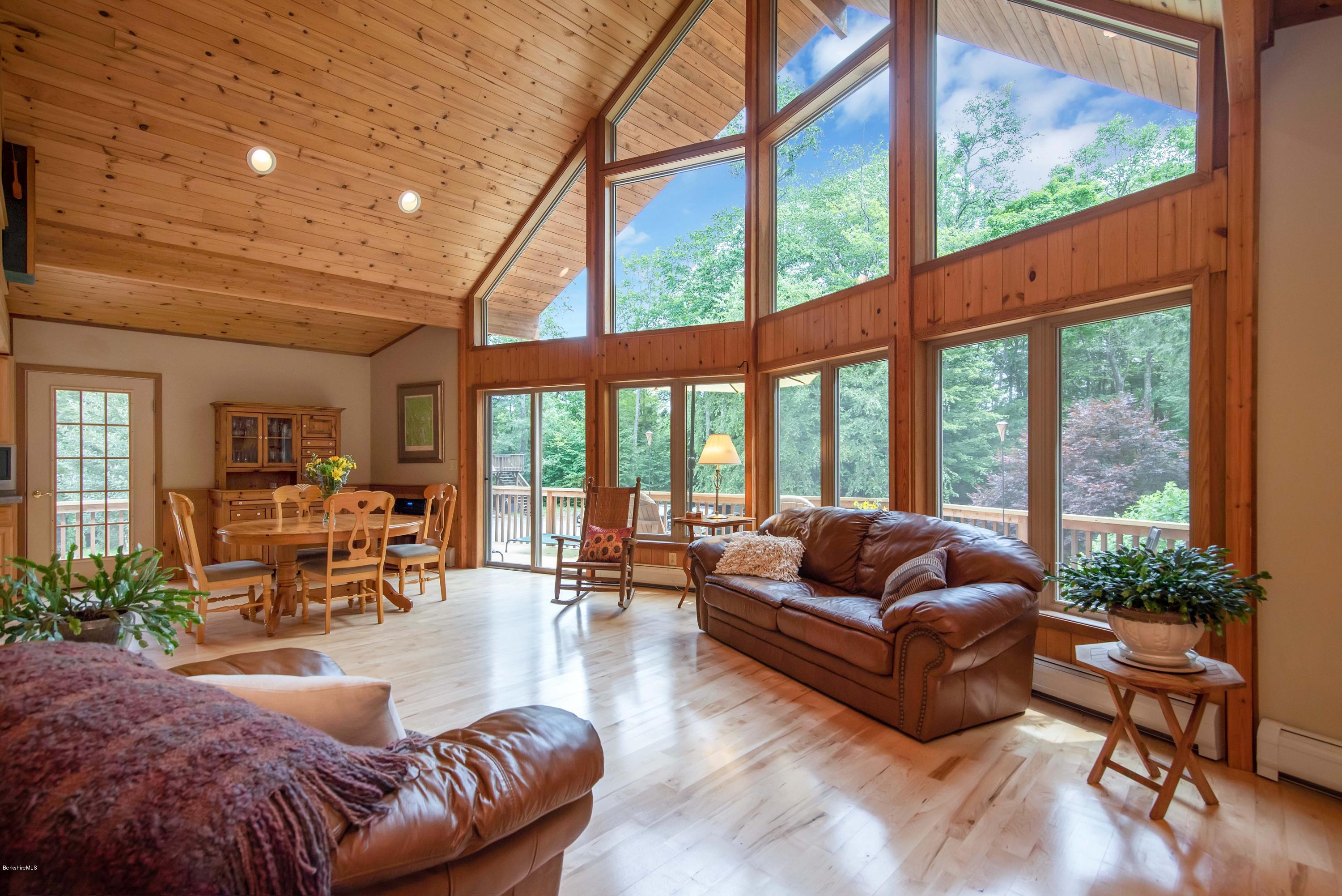 106 Dimmock Road Otis, MA 01253 - Photo 18 of 42 a living room with furniture and floor to ceiling windows