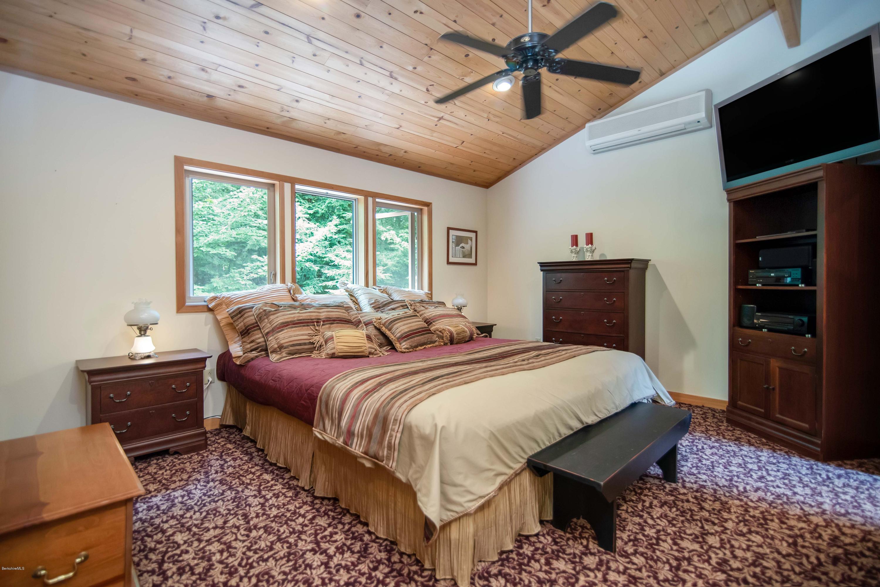 106 Dimmock Road Otis, MA 01253 - Photo 21 of 42 a bedroom with bed and wooden floor