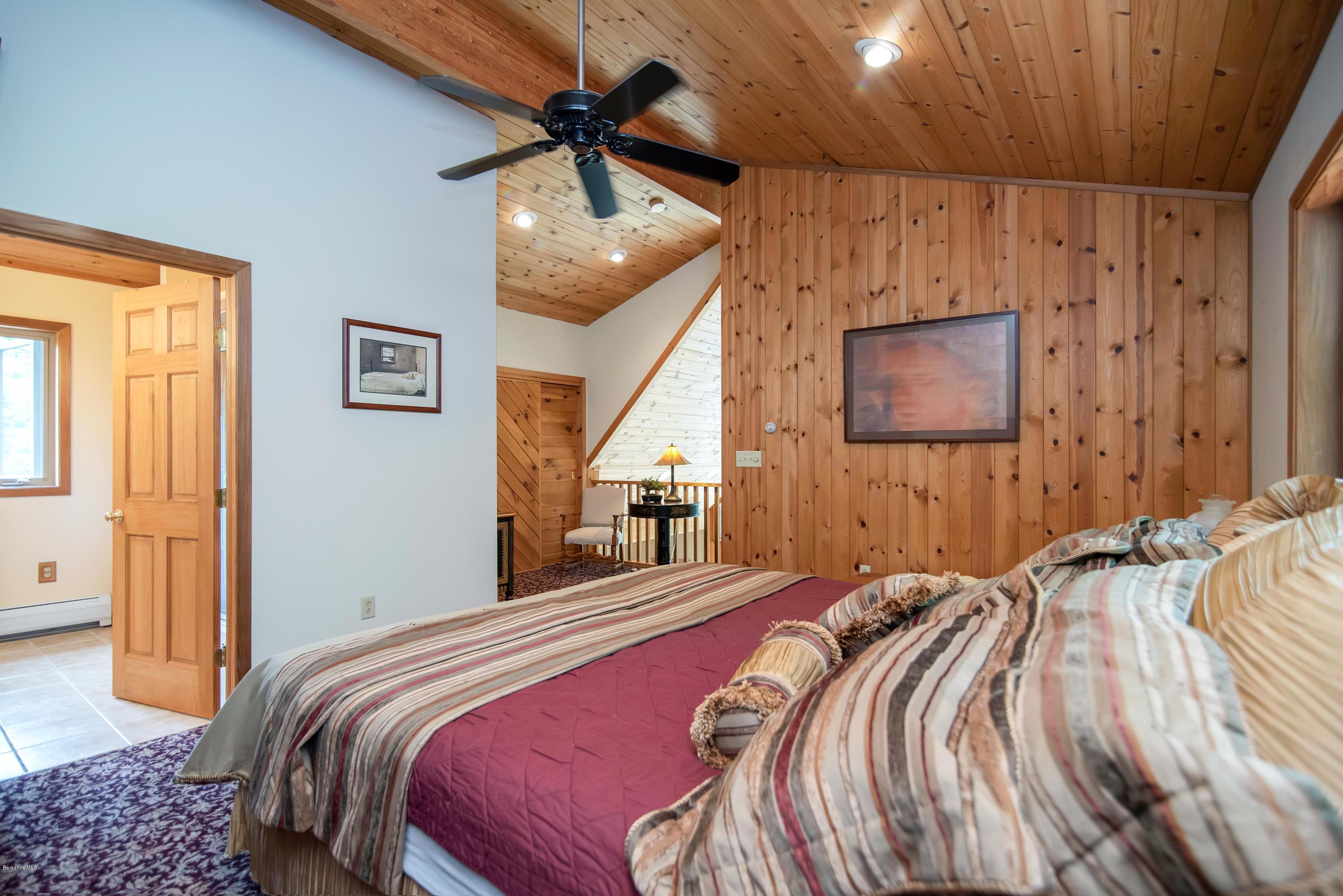 106 Dimmock Road Otis, MA 01253 - Photo 22 of 42 a bedroom with a bed and a chandelier