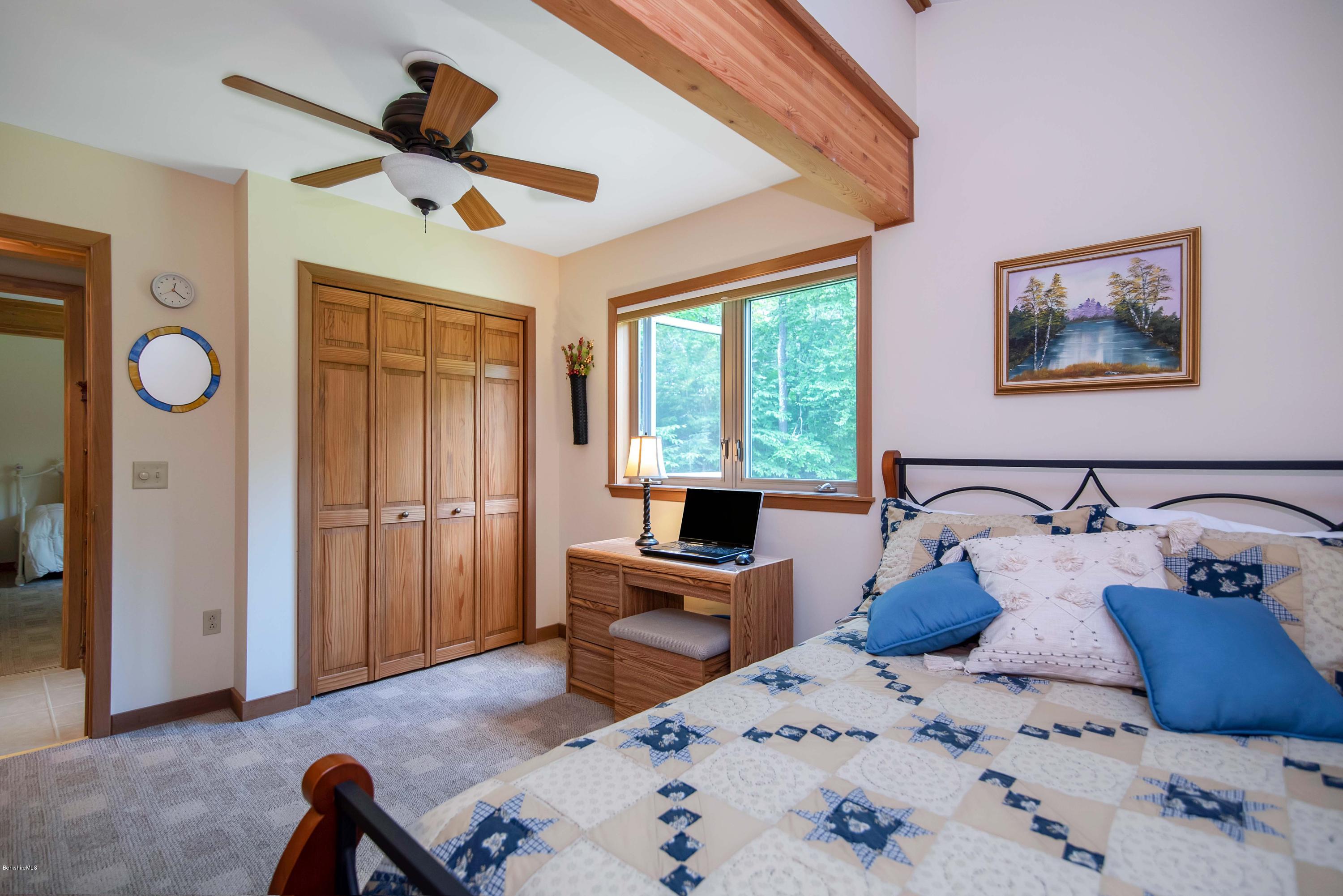 106 Dimmock Road Otis, MA 01253 - Photo 27 of 42 a bedroom with a bed and wooden floor