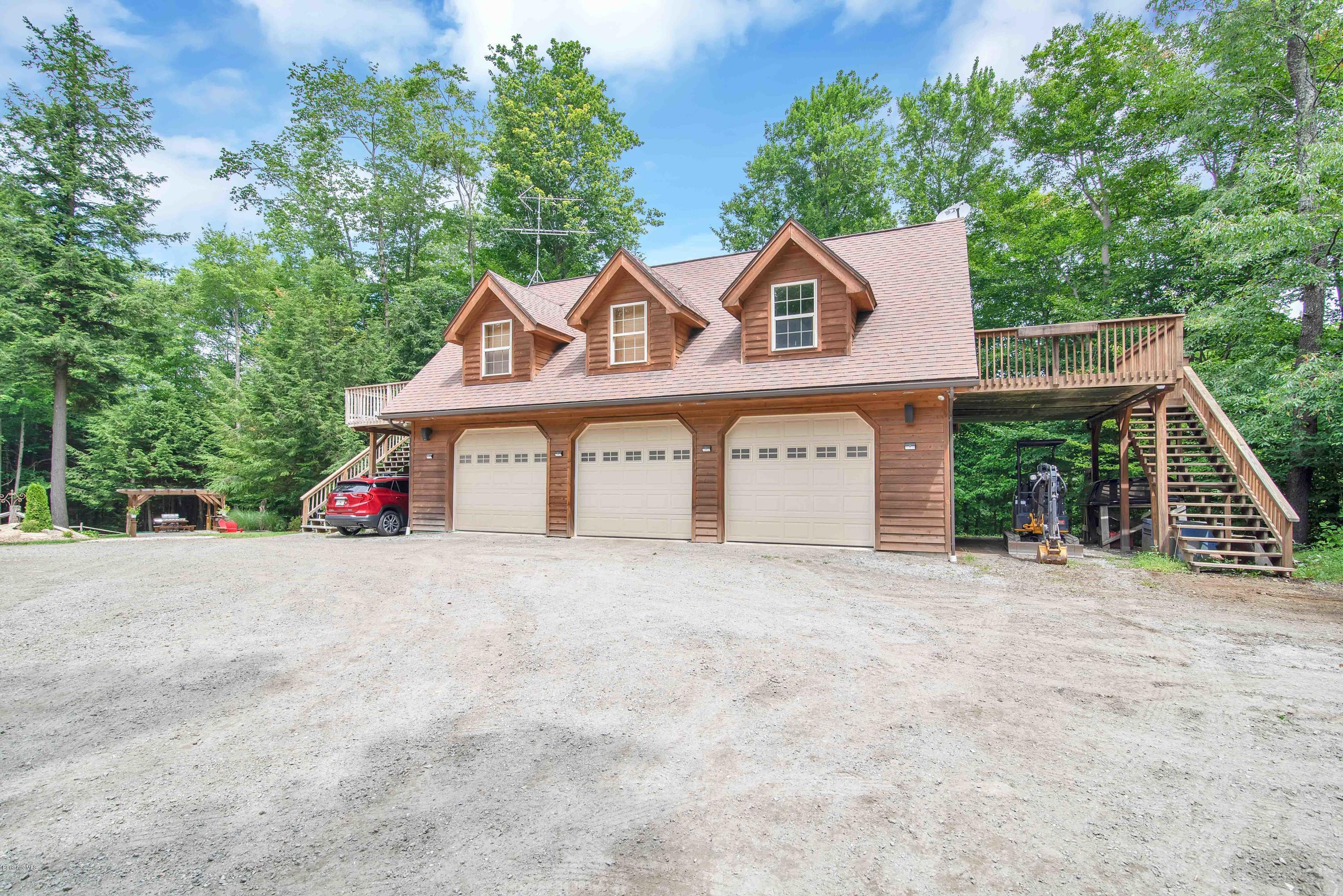 106 Dimmock Road Otis, MA 01253 - Photo 4 of 42 a view of a house with a yard and large trees