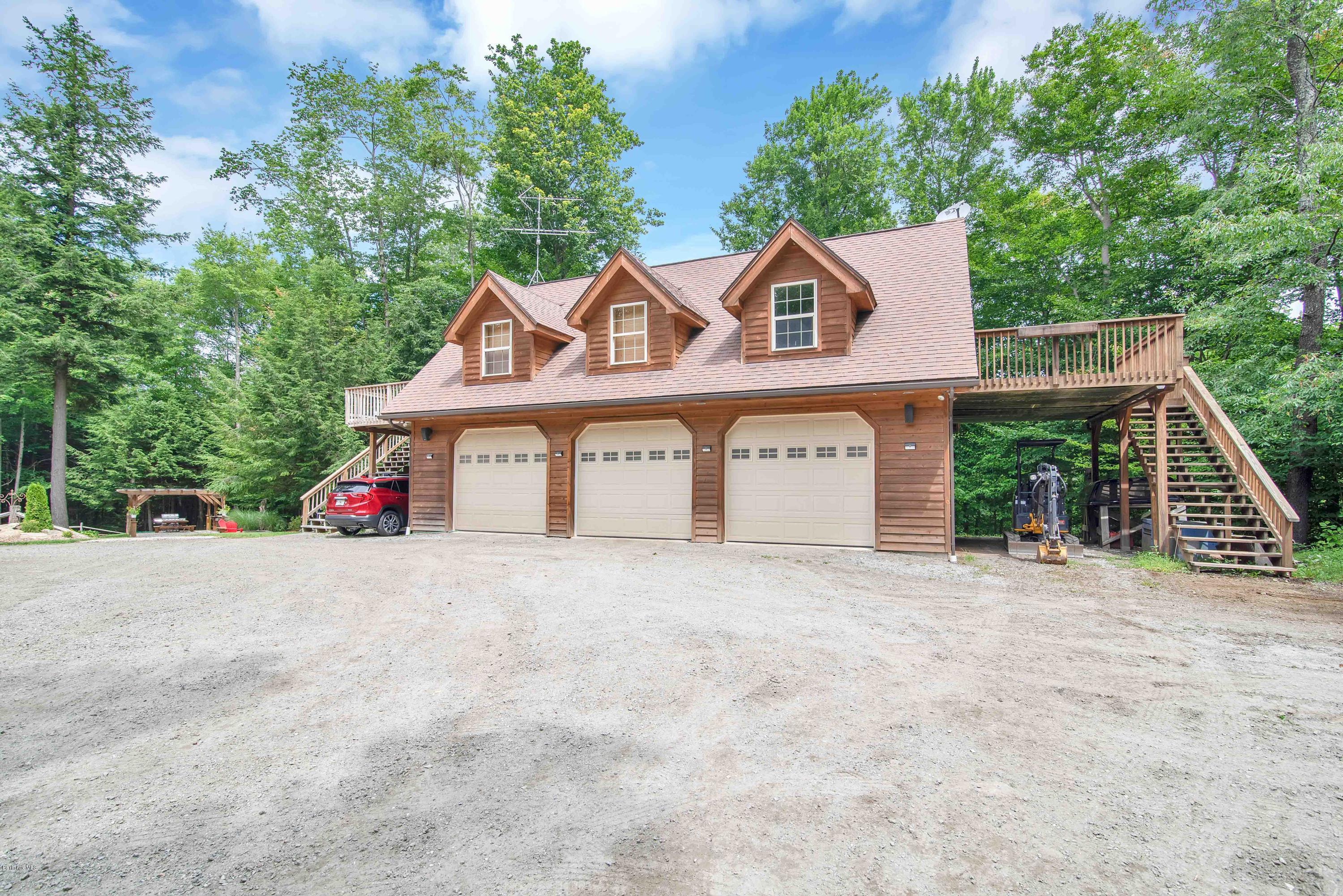 106 Dimmock Road Otis, MA 01253 - Photo 31 of 42 a view of a house with a yard and large trees