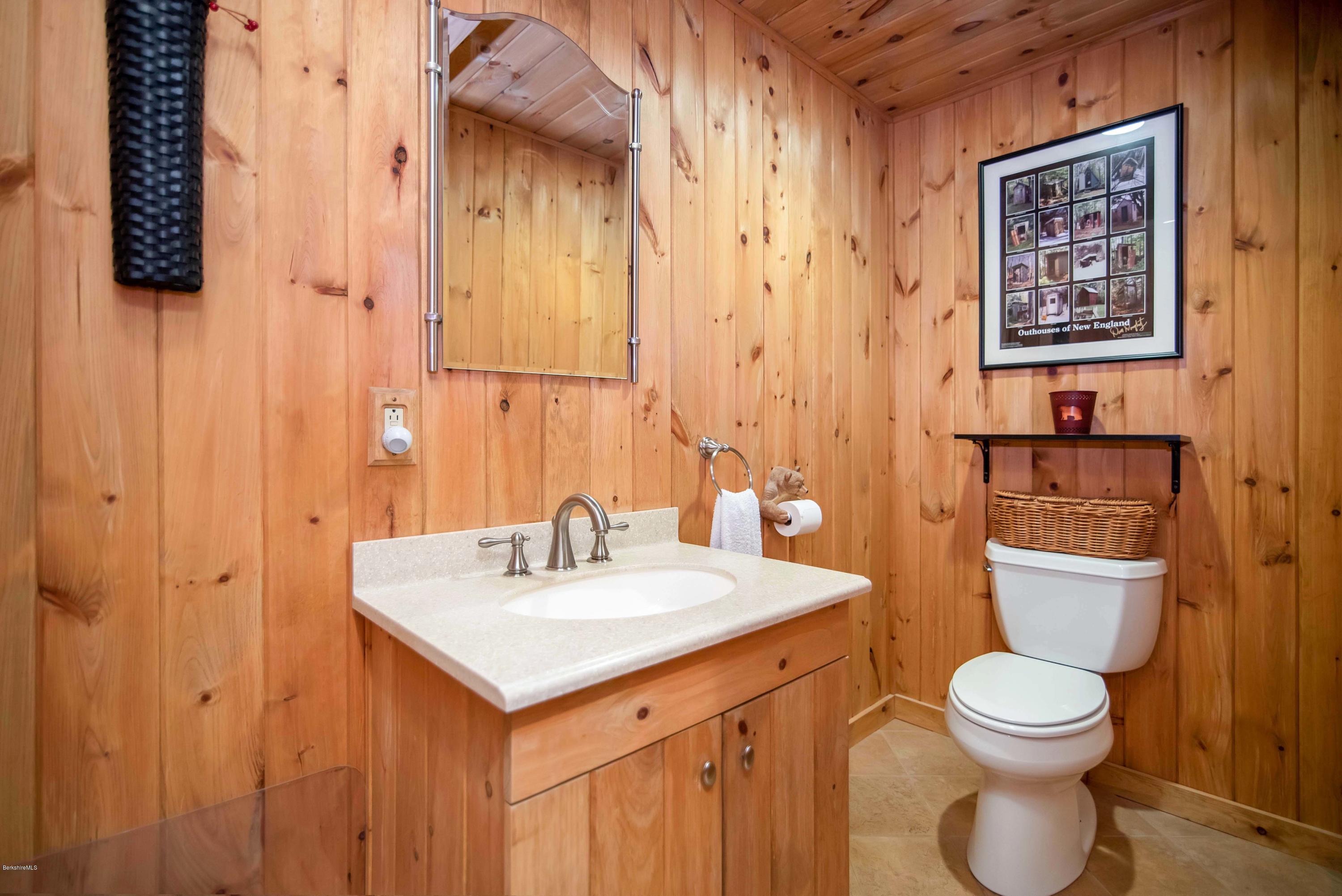 106 Dimmock Road Otis, MA 01253 - Photo 8 of 42 a bathroom with a toilet sink and mirror
