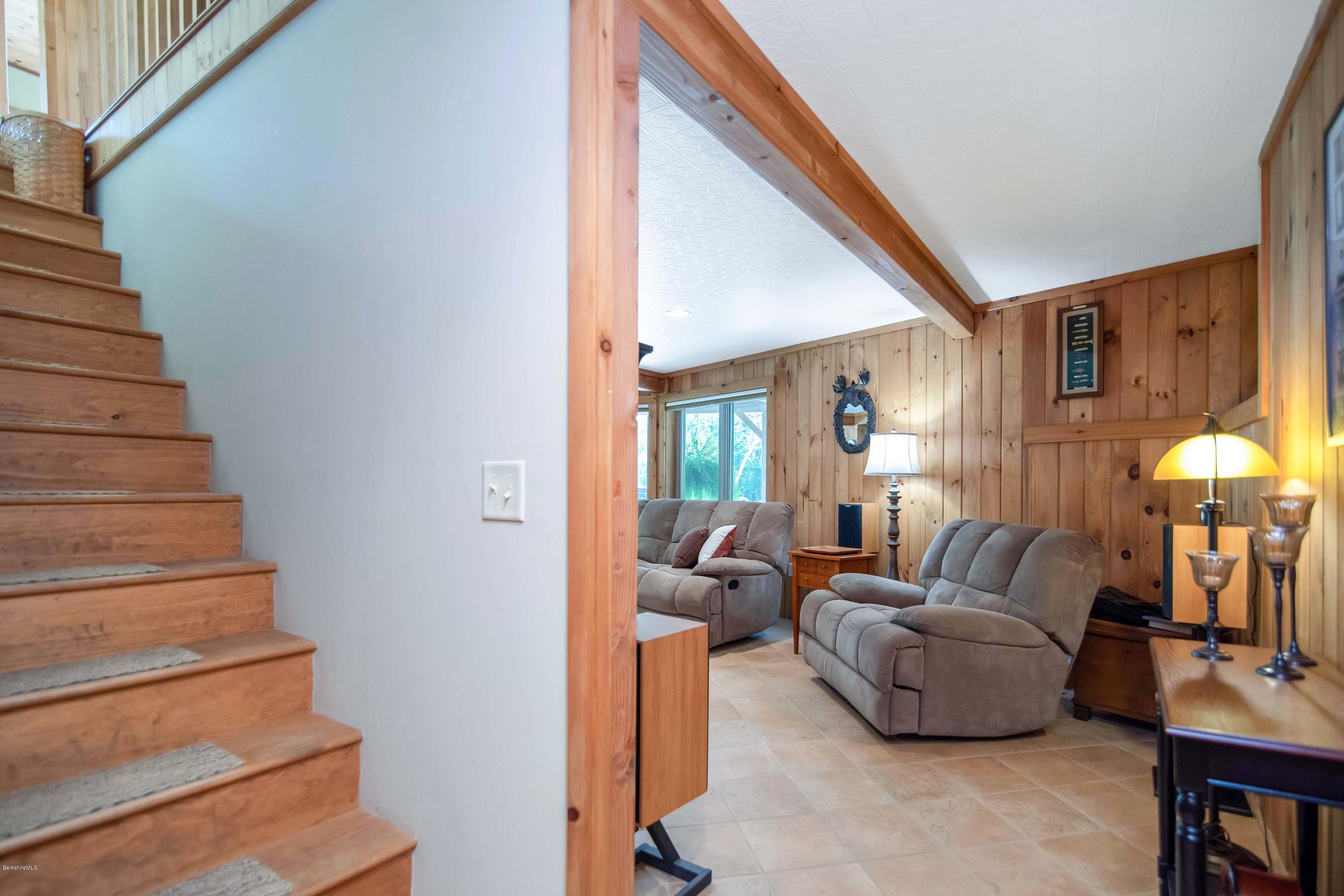 106 Dimmock Road Otis, MA 01253 - Photo 9 of 42 a living room with furniture and a chandelier
