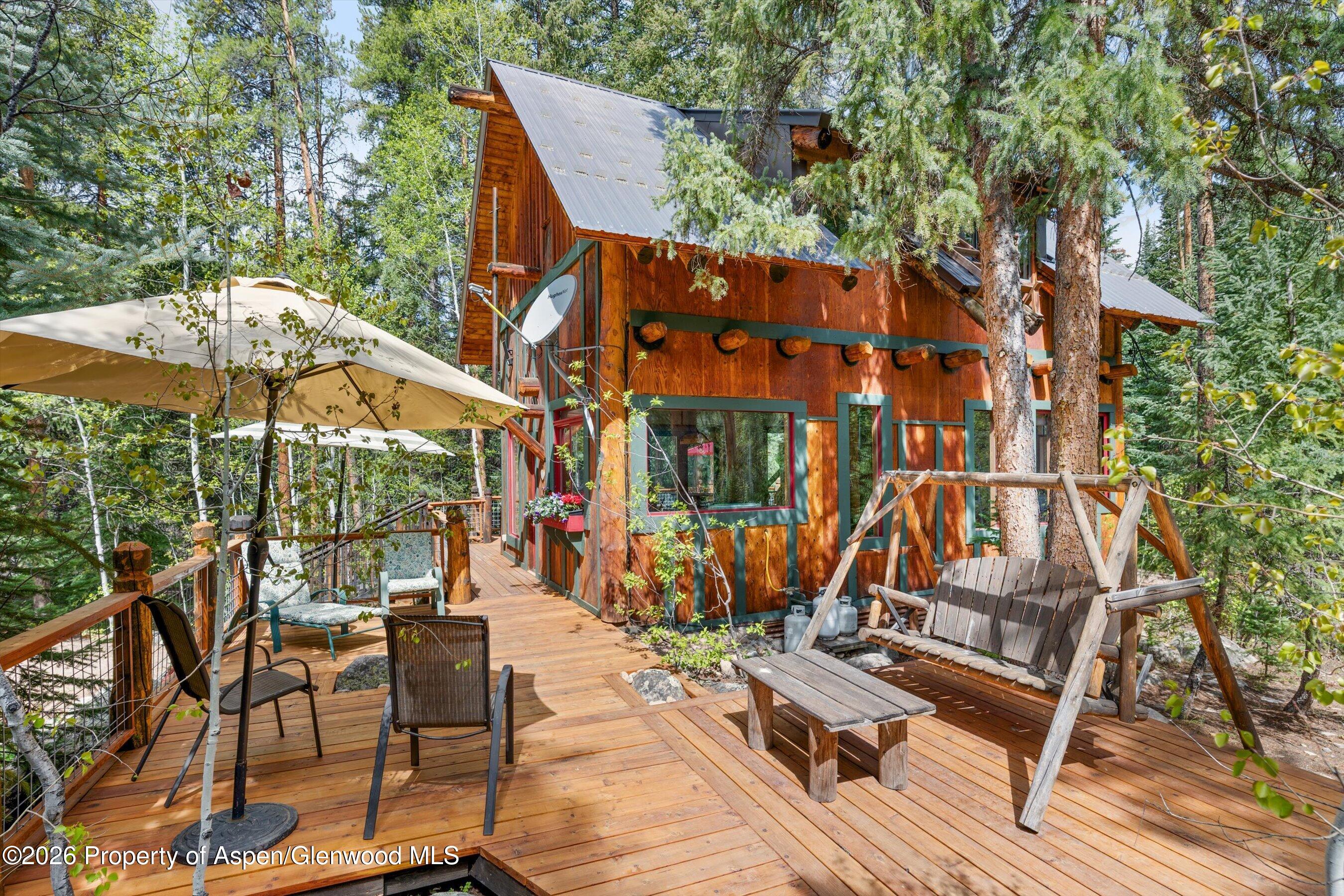 26608 Frying Pan Road Meredith, CO 81642 - Photo 10 of 49 a view of patio with chairs and tables under an umbrella