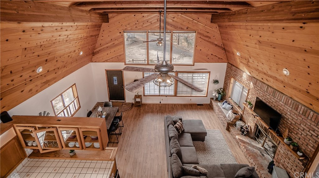 725 Temple Lane Big Bear Lake, CA 92315 - Photo 14 of 65 a view of a fireplace with wooden floor