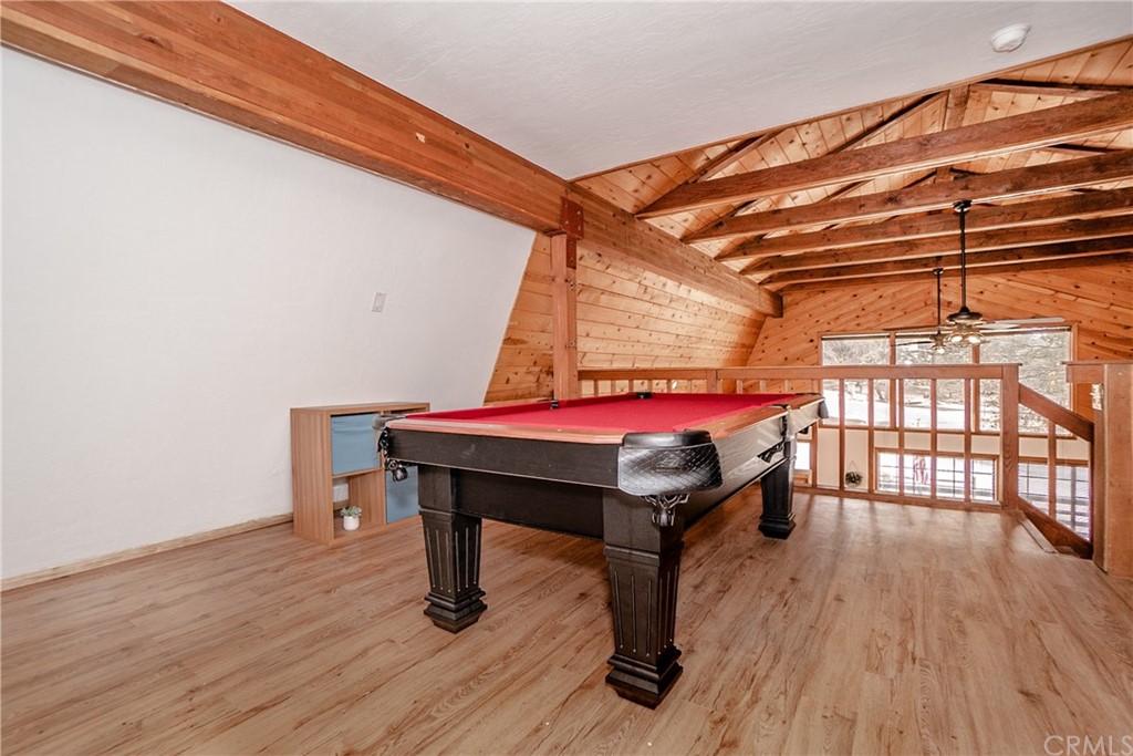 725 Temple Lane Big Bear Lake, CA 92315 - Photo 19 of 65 a room with pool table a window and wooden floor