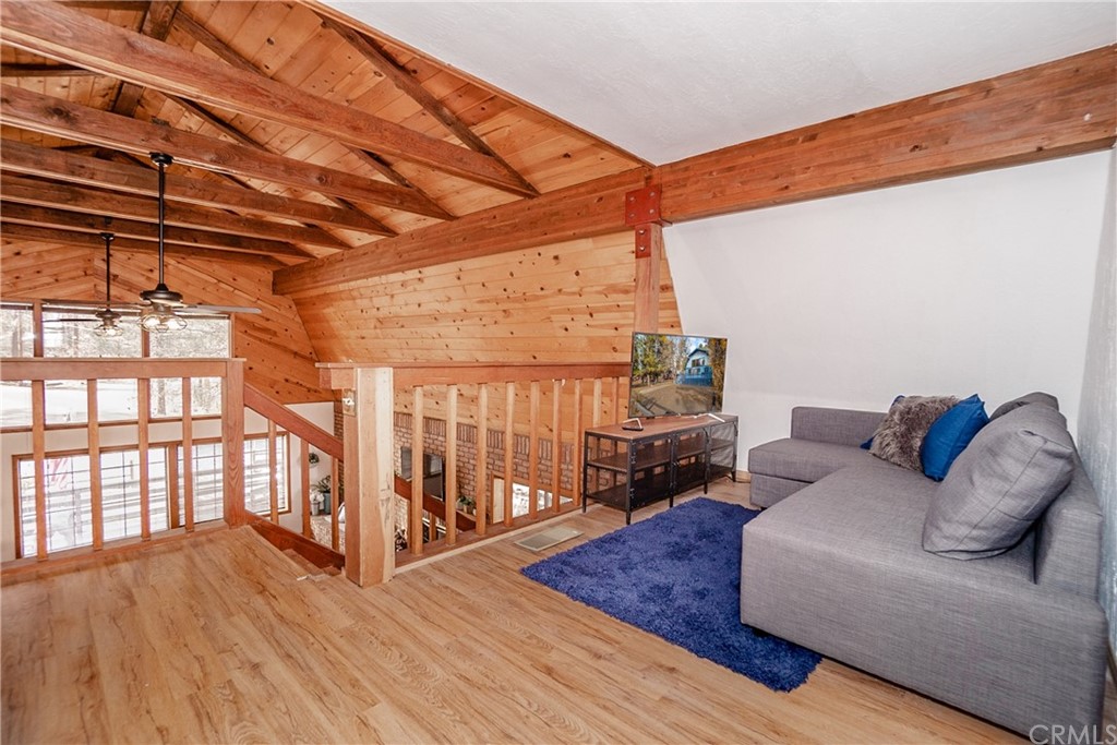 725 Temple Lane Big Bear Lake, CA 92315 - Photo 22 of 65 a living room with furniture a wooden floor and next to a window
