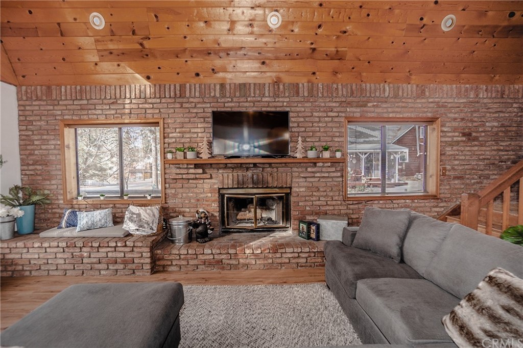 725 Temple Lane Big Bear Lake, CA 92315 - Photo 30 of 65 a living room with furniture a fireplace and a flat screen tv