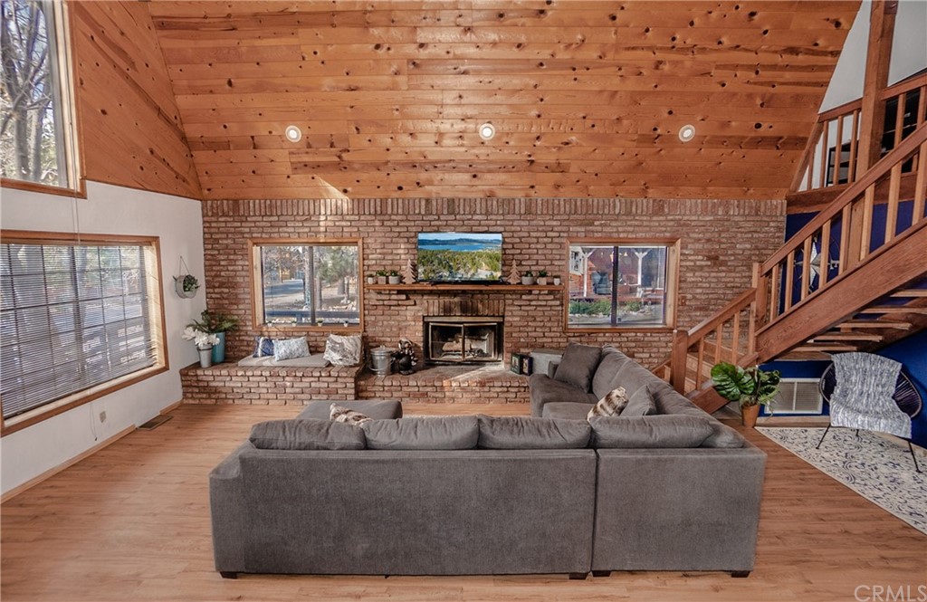 725 Temple Lane Big Bear Lake, CA 92315 - Photo 31 of 65 a living room with fireplace furniture and a wooden floor