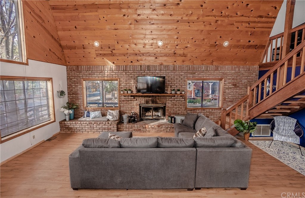 725 Temple Lane Big Bear Lake, CA 92315 - Photo 32 of 65 a living room with furniture a fireplace and a flat screen tv