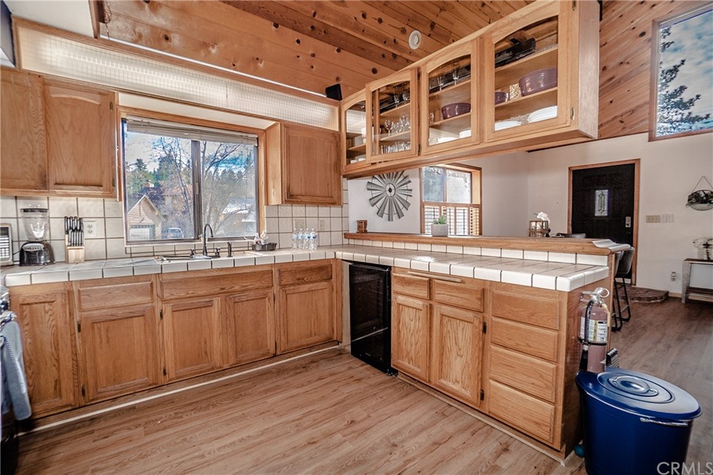 725 Temple Lane Big Bear Lake, CA 92315 - Photo 35 of 65 a kitchen with stainless steel appliances granite countertop a sink stove and wooden cabinets