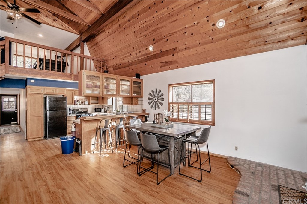 725 Temple Lane Big Bear Lake, CA 92315 - Photo 37 of 65 a view of a dining room with furniture window and wooden floor