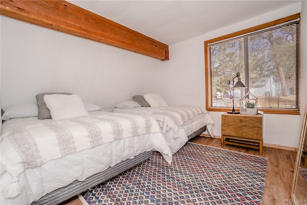 725 Temple Lane Big Bear Lake, CA 92315 - Photo 44 of 65 a bedroom with a bed and wooden floor