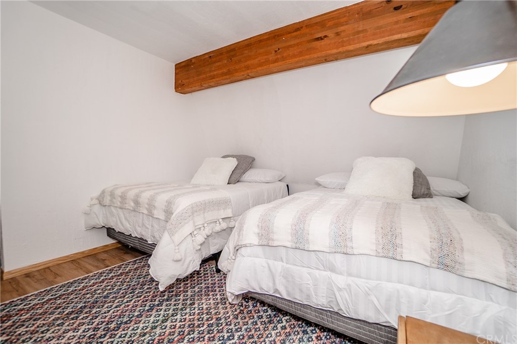 725 Temple Lane Big Bear Lake, CA 92315 - Photo 46 of 65 a bedroom with a bed and a lamp